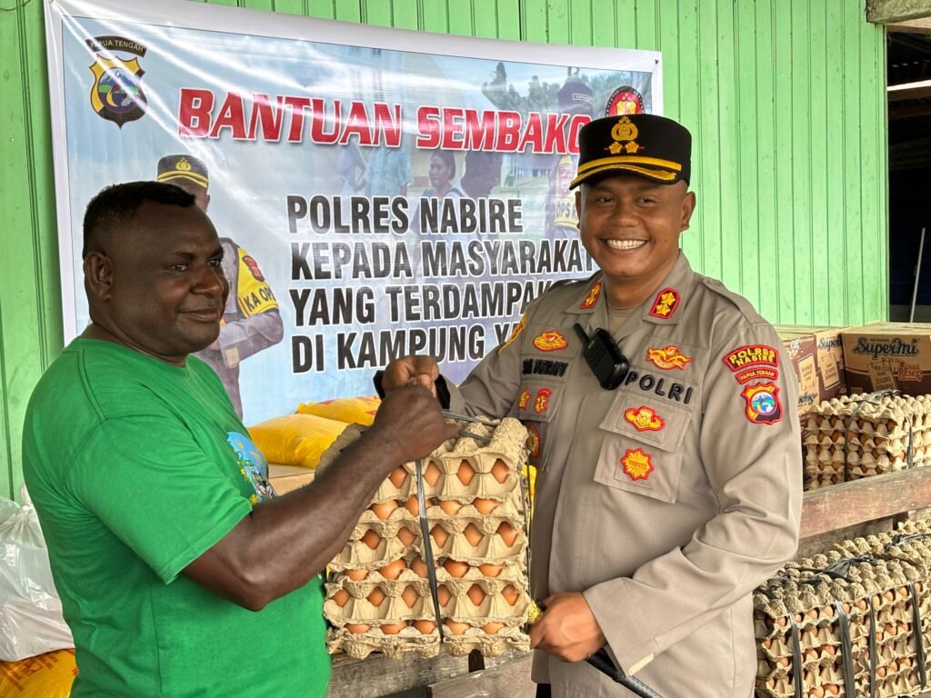 Kapolres Nabire menyerahkan bantuan sembako kepada warga terdampak banjir di Wanggar Pantai, Distrik Yaro.